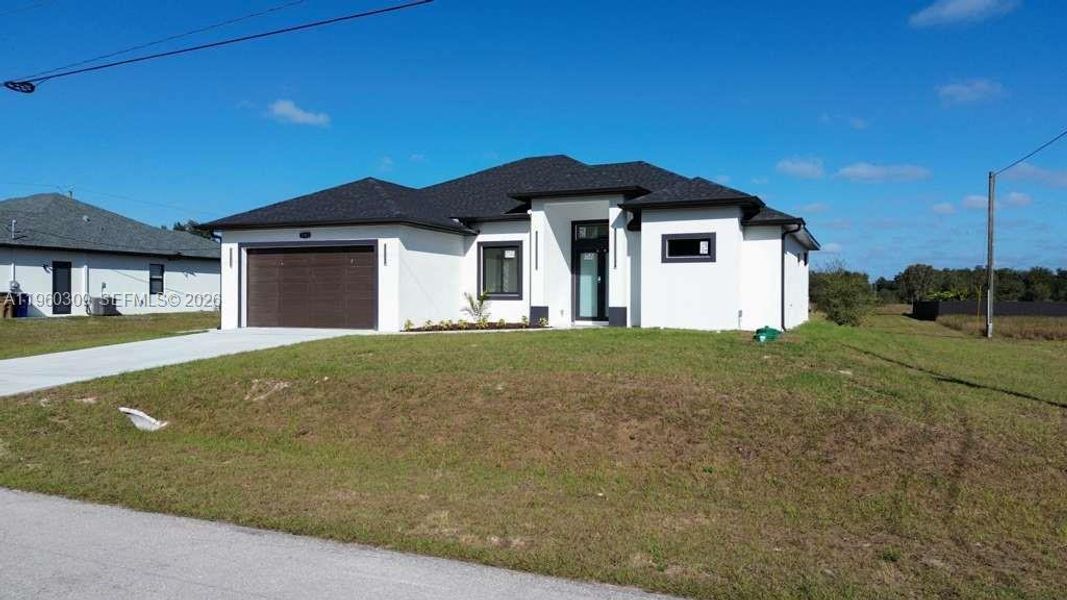 Front exterior of a new home in , Lehigh Acres, FL, highlighting curb appeal (Image 18).