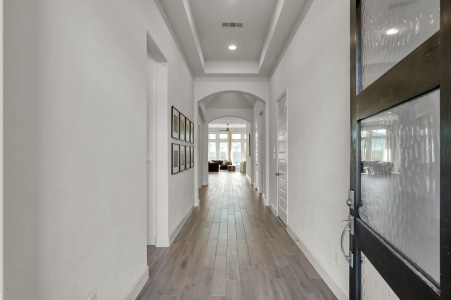 The grand entry and extended hallway create a strong, welcoming first impression. The grand entry and extended hallway create a strong, welcoming first impression.