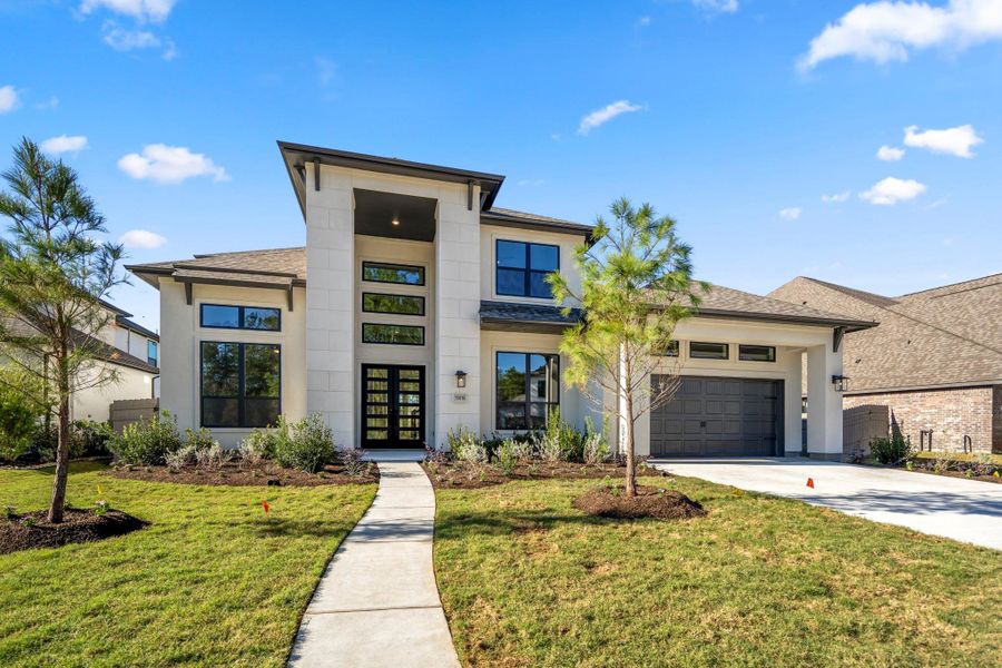 Front exterior of a new home in Artavia 70′ Lots, Conroe, TX, highlighting curb appeal (Image 1).