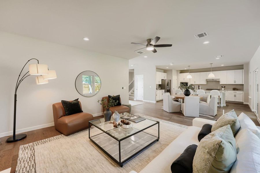 An open floorplan seamlessly connects the living room, dining space, and a well-appointed kitchen. An open floorplan seamlessly connects the living room, dining space, and a well-appointed kitchen.