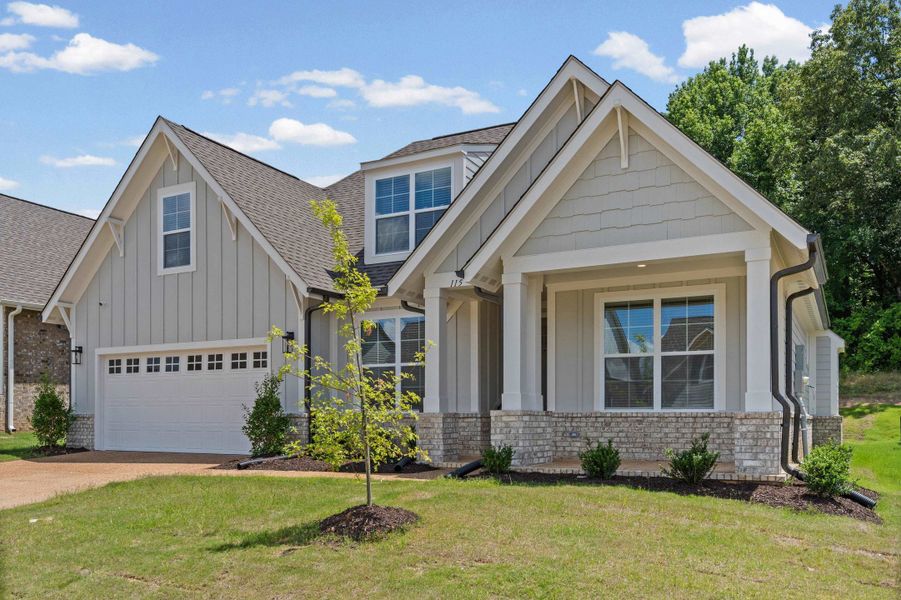 Contemporary Craftsman-style home featuring a covered entry porch, mixed siding and stone facade, a two-car garage, and multiple gabled rooflines Contemporary Craftsman-style home featuring a covered entry porch, mixed siding and stone facade, a two-car garage, and multiple gabled rooflines