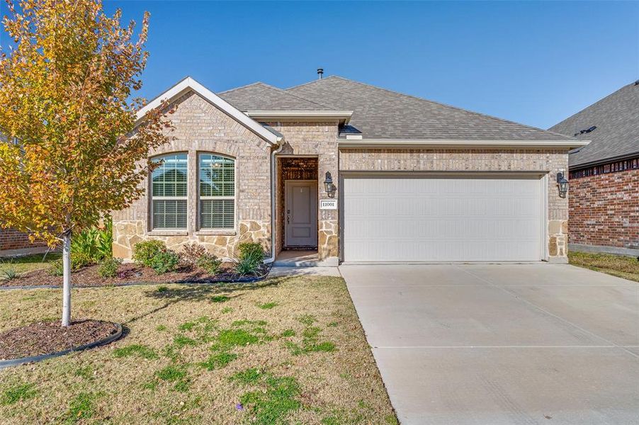 View of front of house with a front yard and a garage