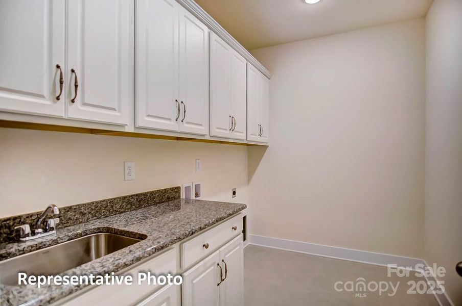 Laundry room will feature cabinets and quartz countertops