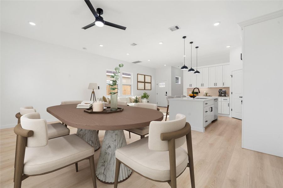 Light-filled dining area with large windows, modern ceiling fan, and ample space for entertaining, perfectly positioned adjacent to the kitchen for everyday living and gatherings. *Virtually Staged Light-filled dining area with large windows, modern ceiling fan, and ample space for entertaining, perfectly positioned adjacent to the kitchen for everyday living and gatherings. *Virtually Staged