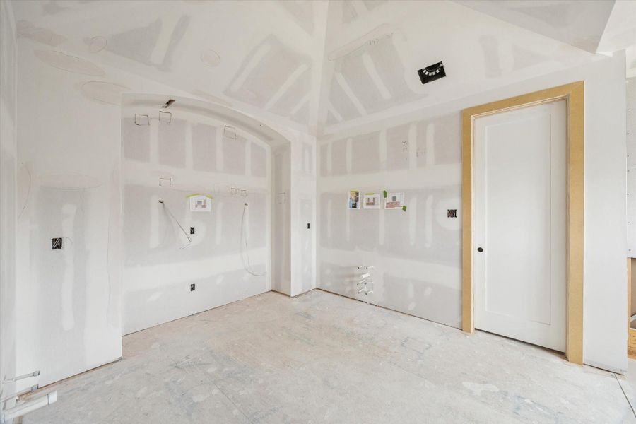 Spa inspired primary bath coming to life with dual vanity layout and a framed walk in shower. Arched detailing and generous ceiling height elevate the space, creating a true retreat within this Oak Forest custom home.