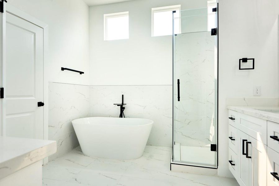 Pamper yourself in this luxurious primary bathroom complete with a separate soaking tub and a glass-enclosed walk-in shower. A tranquil retreat with contemporary finishes, it’s the ideal space to unwind. Pamper yourself in this luxurious primary bathroom complete with a separate soaking tub and a glass-enclosed walk-in shower. A tranquil retreat with contemporary finishes, it’s the ideal space to unwind.