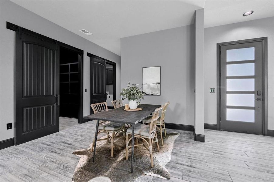 Dining area with light wood-style flooring and baseboards Dining area with light wood-style flooring and baseboards