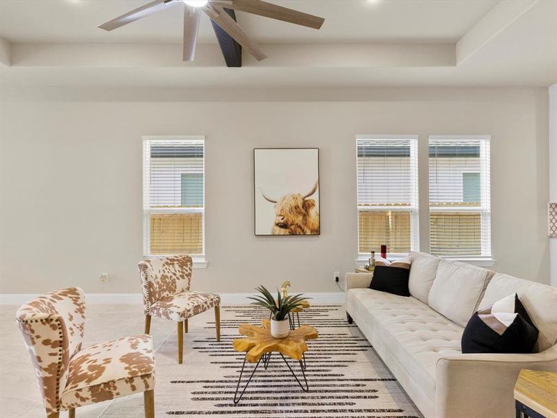 Living room with a wealth of natural light and ceiling fan