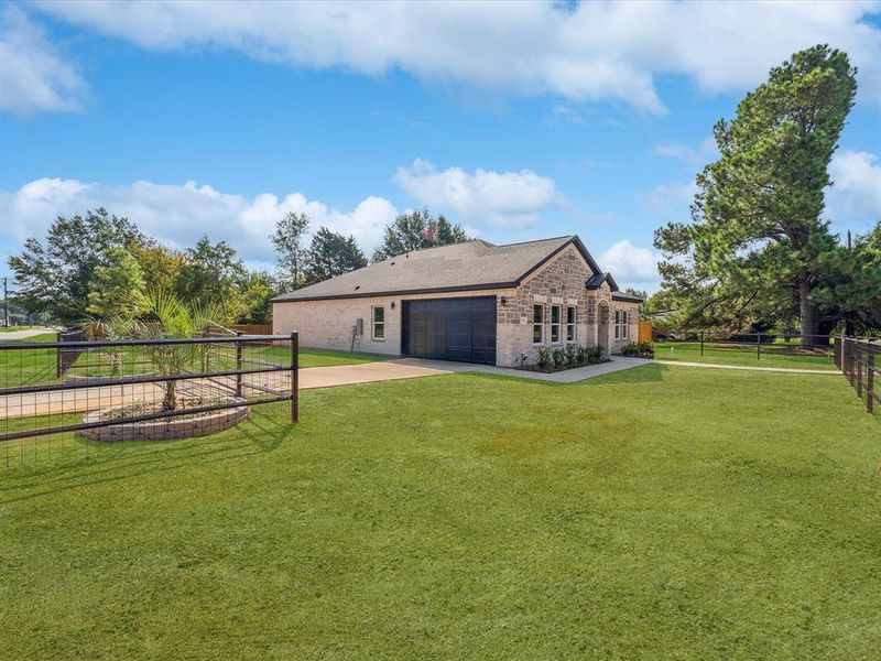 View of side of home featuring concrete driveway and brick siding