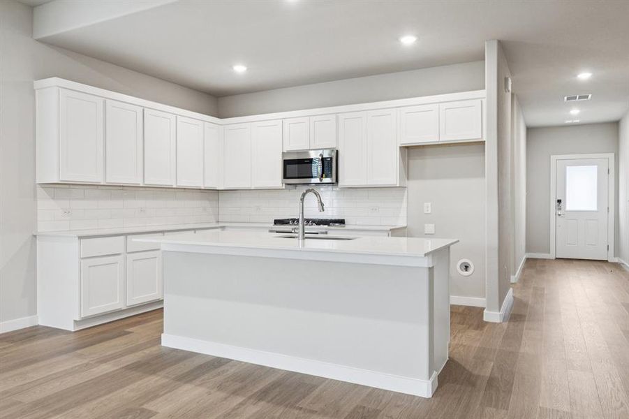 Kitchen in the Stanley II home plan by Trophy Signature Homes – REPRESENTATIVE PHOTO