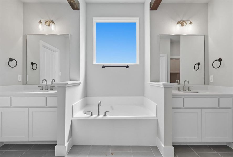 Bathroom featuring tile patterned floors, a bath, and two vanities Bathroom featuring tile patterned floors, a bath, and two vanities