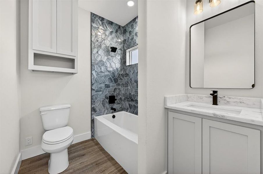 Full bath featuring vanity, shower / washtub combination, and light wood finished floors
