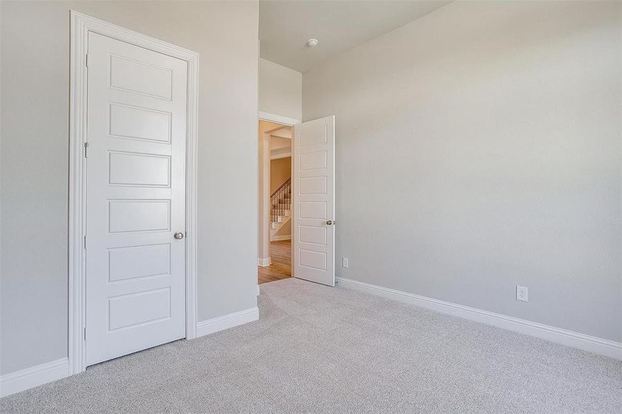 Unfurnished bedroom featuring light carpet