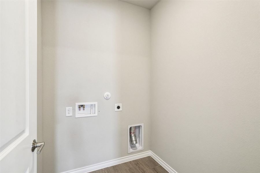 Washroom featuring hookup for an electric dryer, washer hookup, dark wood-type flooring, and hookup for a gas dryer