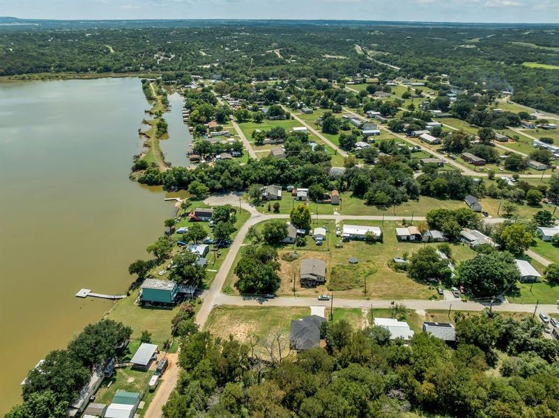 Aerial view of property and surrounding area with a large body of water Aerial view of property and surrounding area with a large body of water
