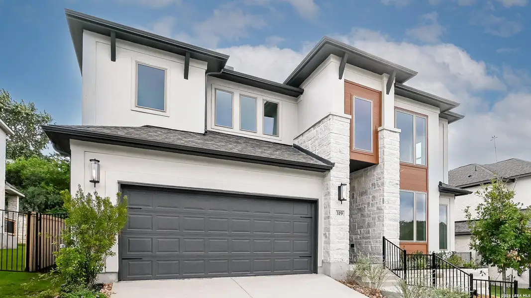 Front exterior of a new home in Hidden Canyon, San Antonio, TX, highlighting curb appeal (Image 17).