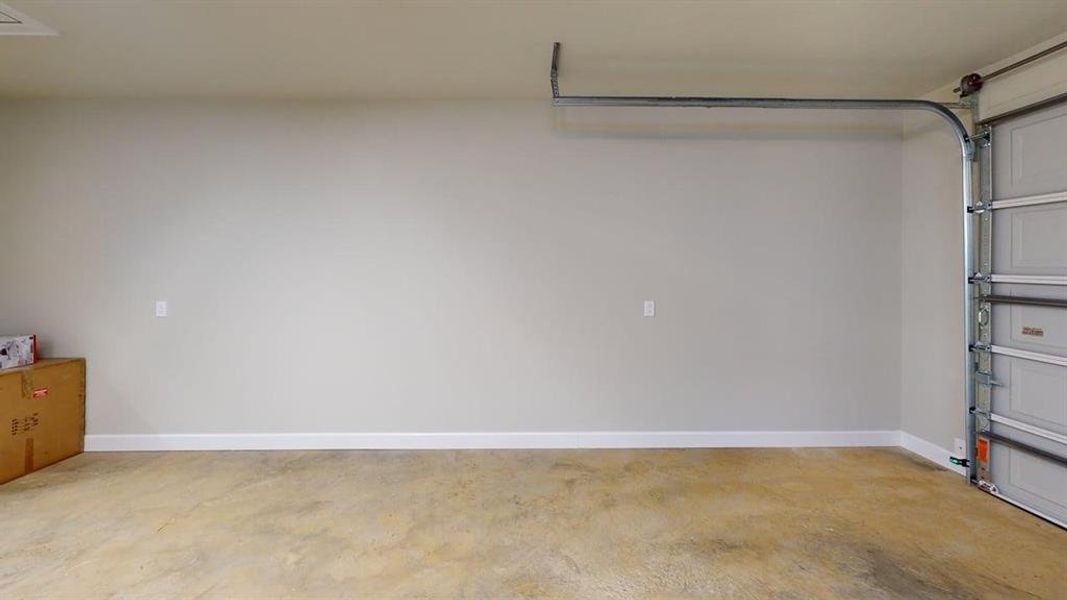 Garage featuring baseboards