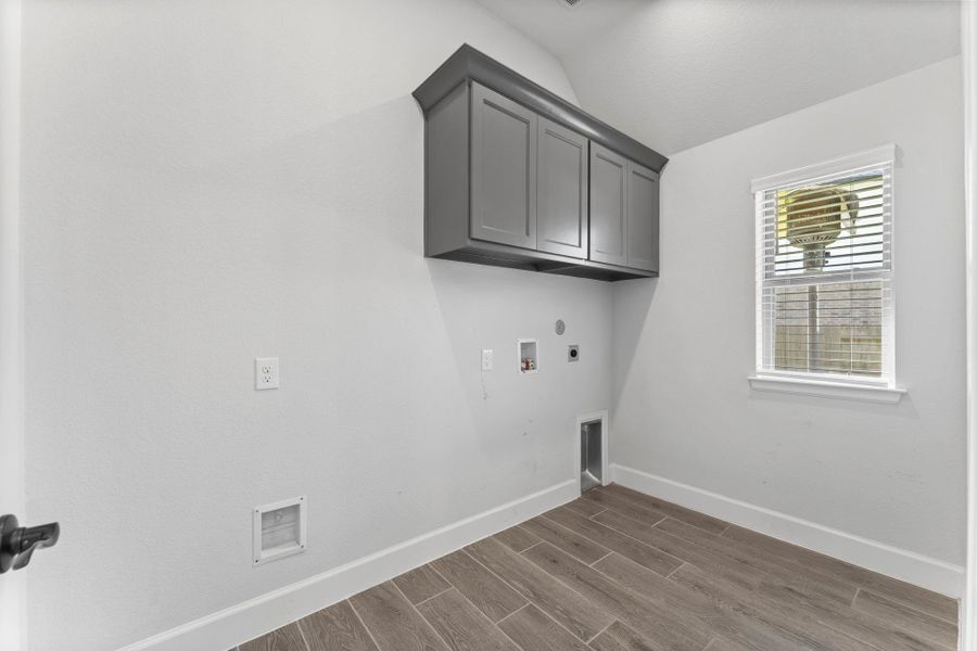 Bright, functional laundry room with a view and upgraded cabinets. Bright, functional laundry room with a view and upgraded cabinets.