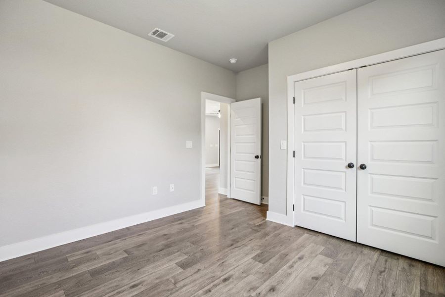 Unfurnished bedroom with light wood finished floors and a closet