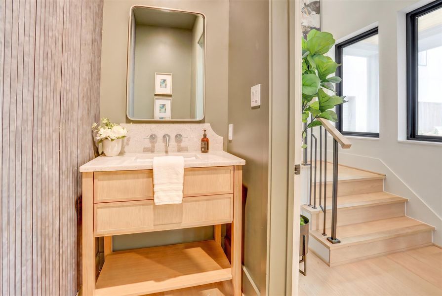 The first-floor powder bath sits conveniently at the front of the home with a beautiful accent wall.