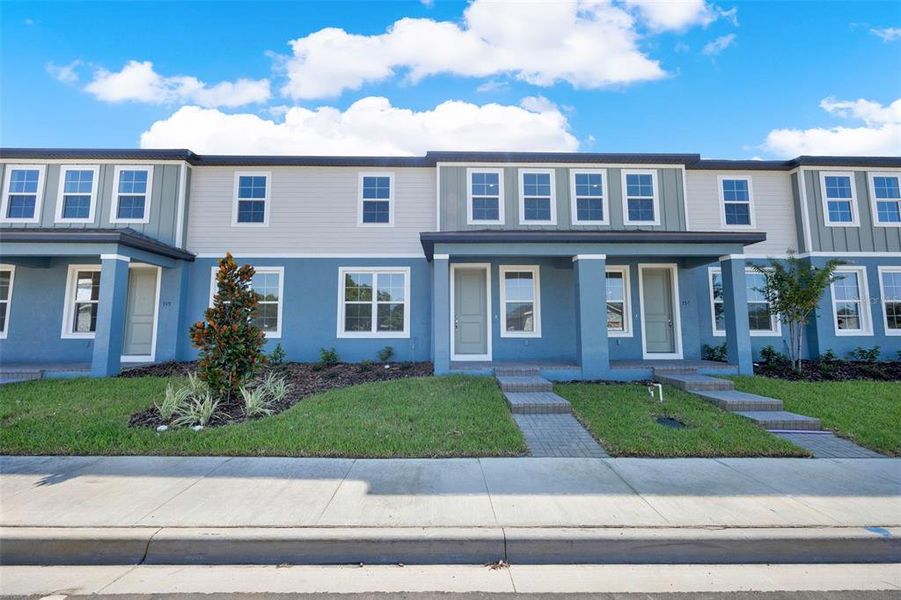Front exterior of a new home in Eden Crest, Apopka, FL, highlighting curb appeal (Image 19).