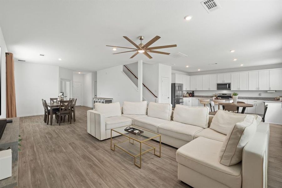 An open concept floorplan, fabulous flooring and tons of natural lighting from WALL OF WINDOWS greet you upon entry into this Luxurious Living Room!