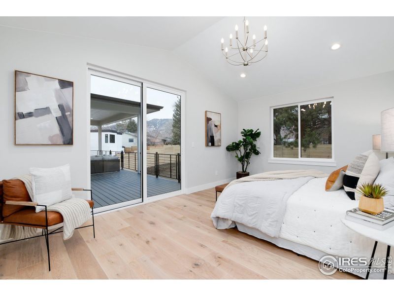 Primary Bedroom with walk-out to backyard with views and trex deck access.