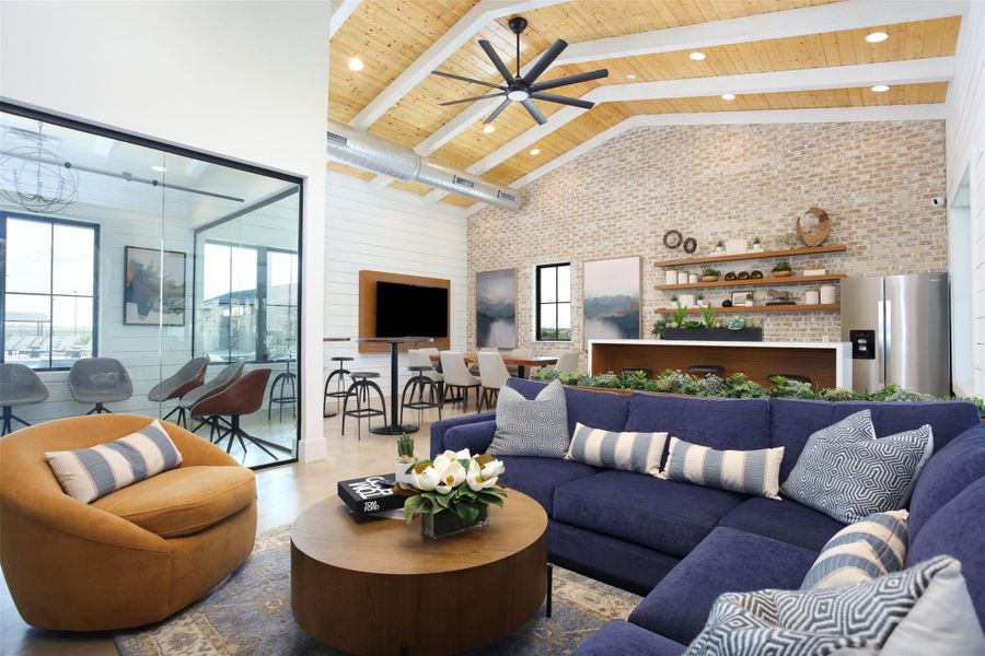 Living area with brick wall, ceiling fan, beam ceiling, wooden ceiling, and high vaulted ceiling