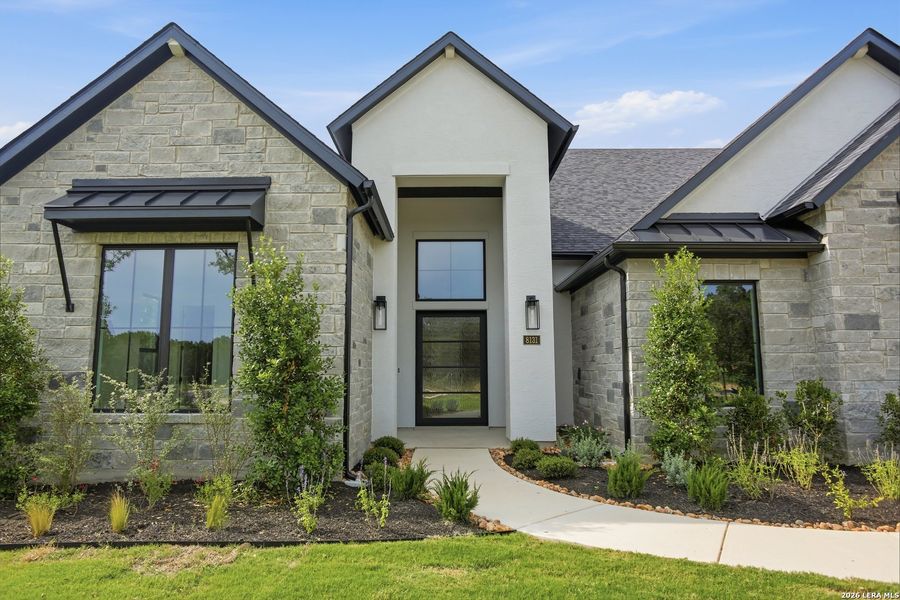 Front exterior of a new home in Enchanted Bluff, San Antonio, TX, highlighting curb appeal (Image 29).