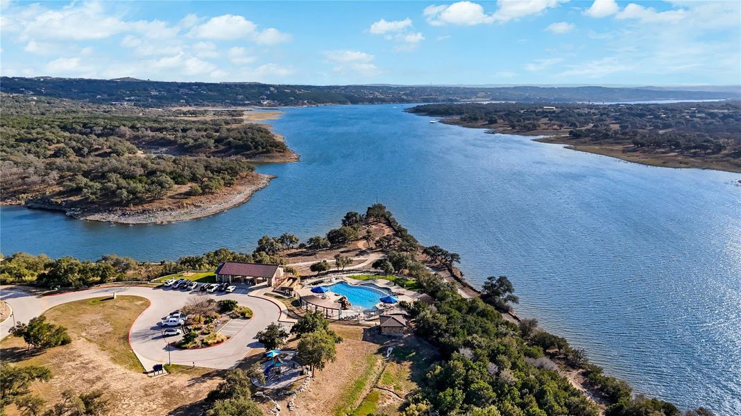 A winding river stretches toward the horizon beneath a vast, blue sky. A winding river stretches toward the horizon beneath a vast, blue sky.
