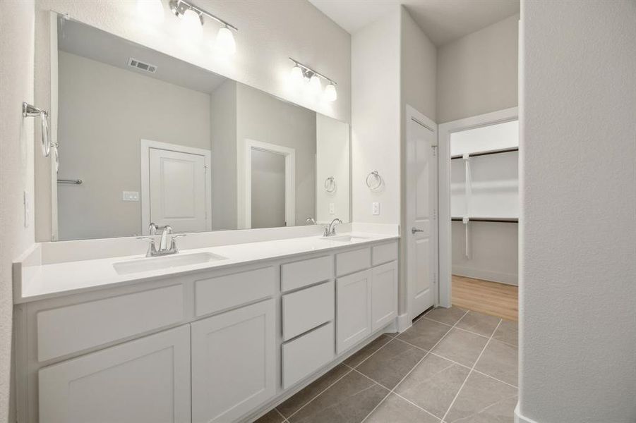 Bathroom with tile patterned floors and vanity