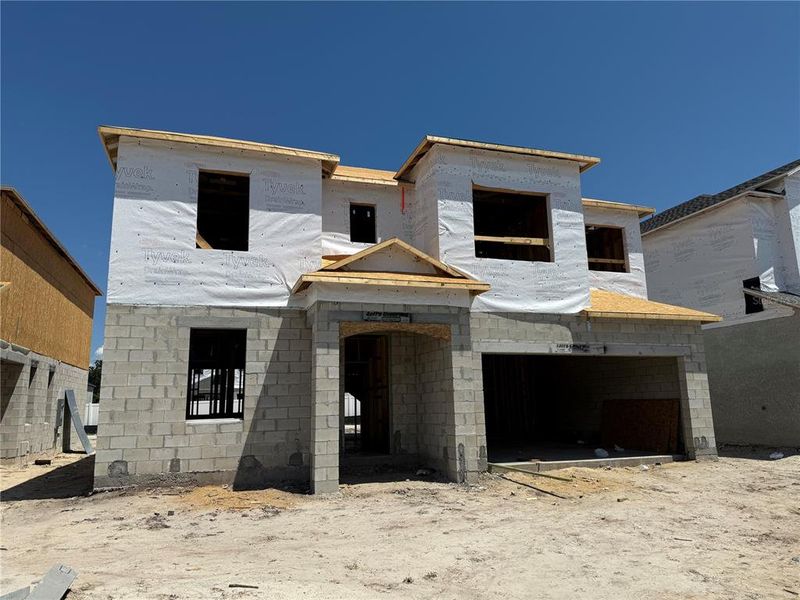 Front exterior of a new home in Estates at Rivercrest, Sanford, FL, highlighting curb appeal (Image 1). Front exterior of a new home in Estates at Rivercrest, Sanford, FL, highlighting curb appeal (Image 1).