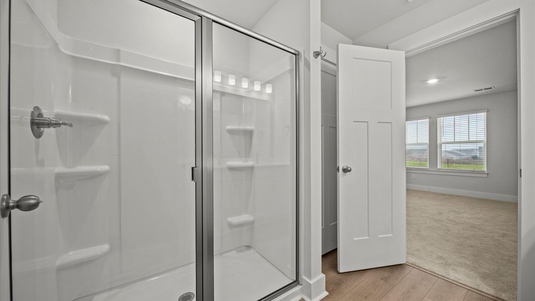 Exceptional en-suite with dual vanity and glass-enclosed walk-in shower for superior everyday comfort
