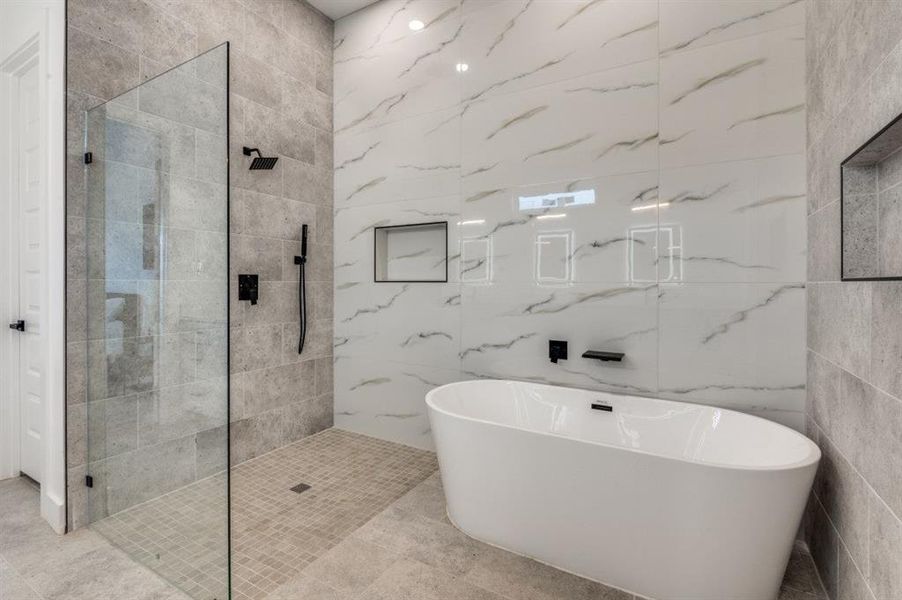 Luxurious primary bathroom featuring a 14-foot vanity with anti-fog lighting mirrors, massive walk-in closet, and spa-inspired shower and soaking tub with multiple showerheads. Luxurious primary bathroom featuring a 14-foot vanity with anti-fog lighting mirrors, massive walk-in closet, and spa-inspired shower and soaking tub with multiple showerheads.