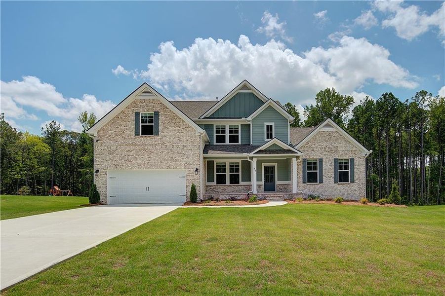 Front exterior of a new home in Saddleridge, Senoia, GA, highlighting curb appeal (Image 1).