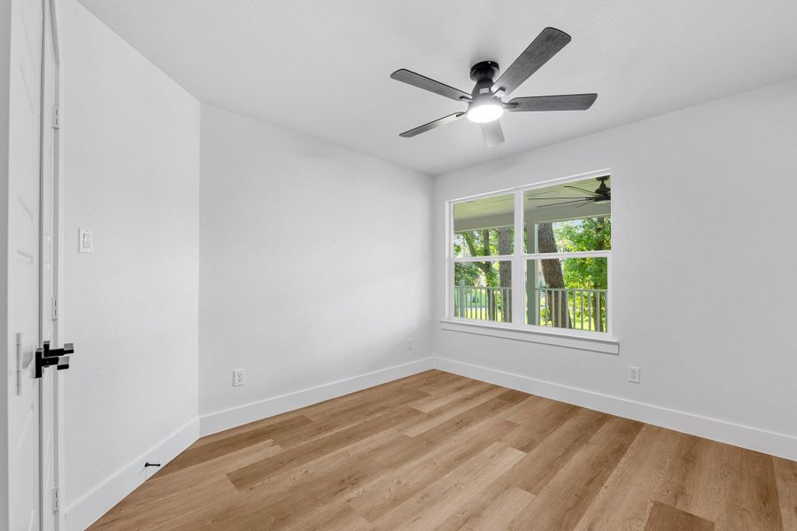 Spacious third bedroom with natural light and serene views. Spacious third bedroom with natural light and serene views.