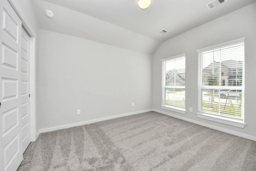 Generously sized secondary bedrooms featuring spacious closets, soft and inviting carpeting underfoot, large windows allowing plenty of natural light, and the added touch of privacy blinds for your personal retreat. Sample photo of completed home with similar floor plan. Actual colors and selections may vary. Generously sized secondary bedrooms featuring spacious closets, soft and inviting carpeting underfoot, large windows allowing plenty of natural light, and the added touch of privacy blinds for your personal retreat. Sample photo of completed home with similar floor plan. Actual colors and selections may vary.