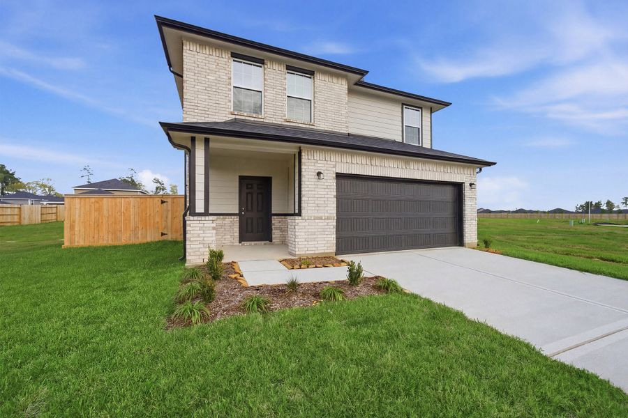Front exterior of a new home in The Canopies, Splendora, TX, highlighting curb appeal (Image 2).