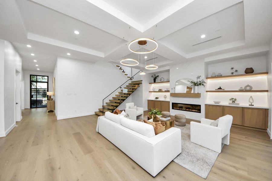 Living room showcasing a tile-accented center console with an electric fireplace.