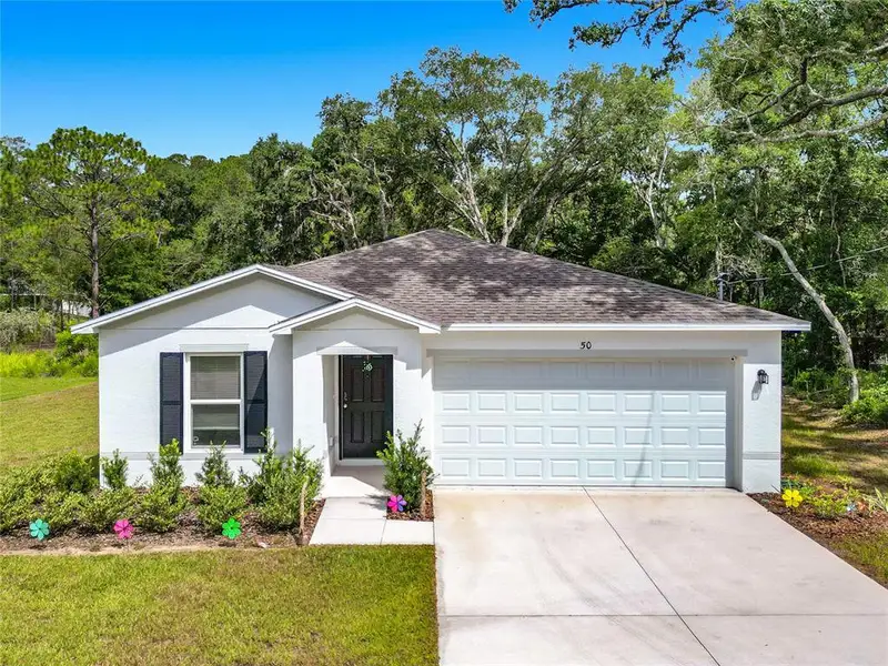 Front exterior of a new home in The Collection at Ocklawaha, Ocklawaha, FL, highlighting curb appeal (Image 28). Front exterior of a new home in The Collection at Ocklawaha, Ocklawaha, FL, highlighting curb appeal (Image 28).