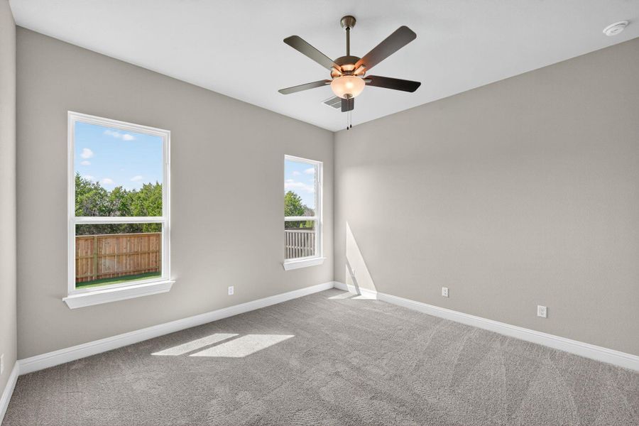 Spare room featuring carpet and ceiling fan Spare room featuring carpet and ceiling fan