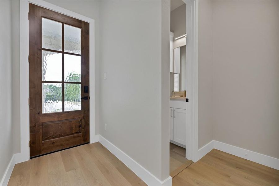 Entryway with light wood finished floors and baseboards Entryway with light wood finished floors and baseboards