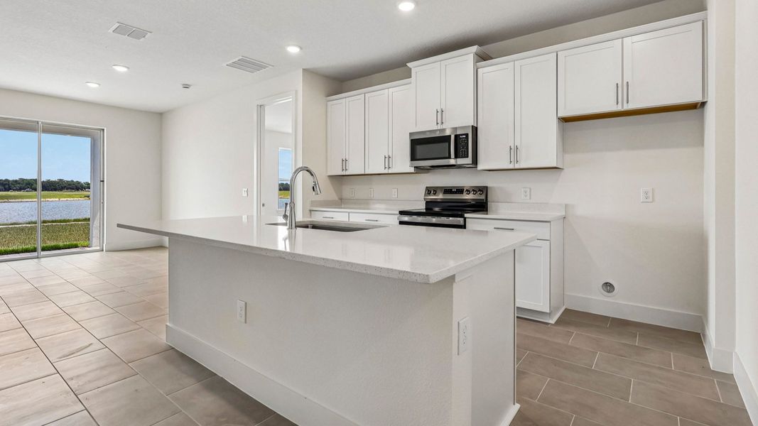 Longleaf Floor Plan Kitchen and Island with overhang for seating by DRB Homes in Trailside New Homes in Mount Dora Fl Longleaf Floor Plan Kitchen and Island with overhang for seating by DRB Homes in Trailside New Homes in Mount Dora Fl