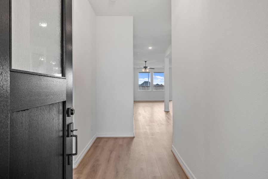 Feel at home from the start—an inviting entryway leads you into the heart of the open living area.