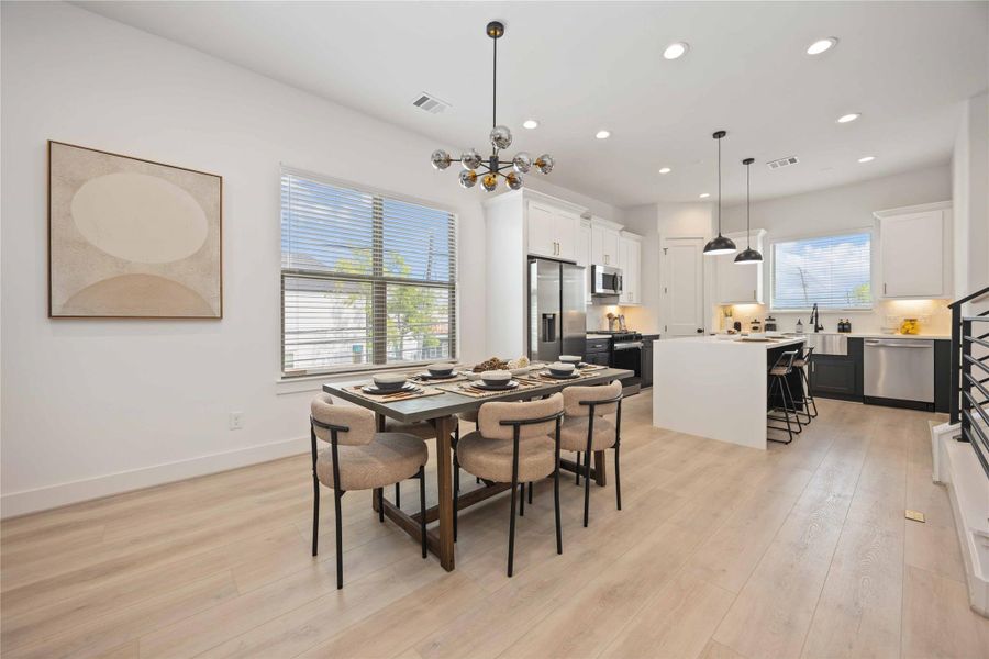 Open concept living/dining/kitchen. Photo of the model home. Finishes & specifications may vary.