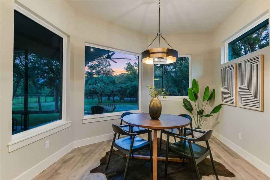Dining area with baseboards and light wood-style floors Dining area with baseboards and light wood-style floors