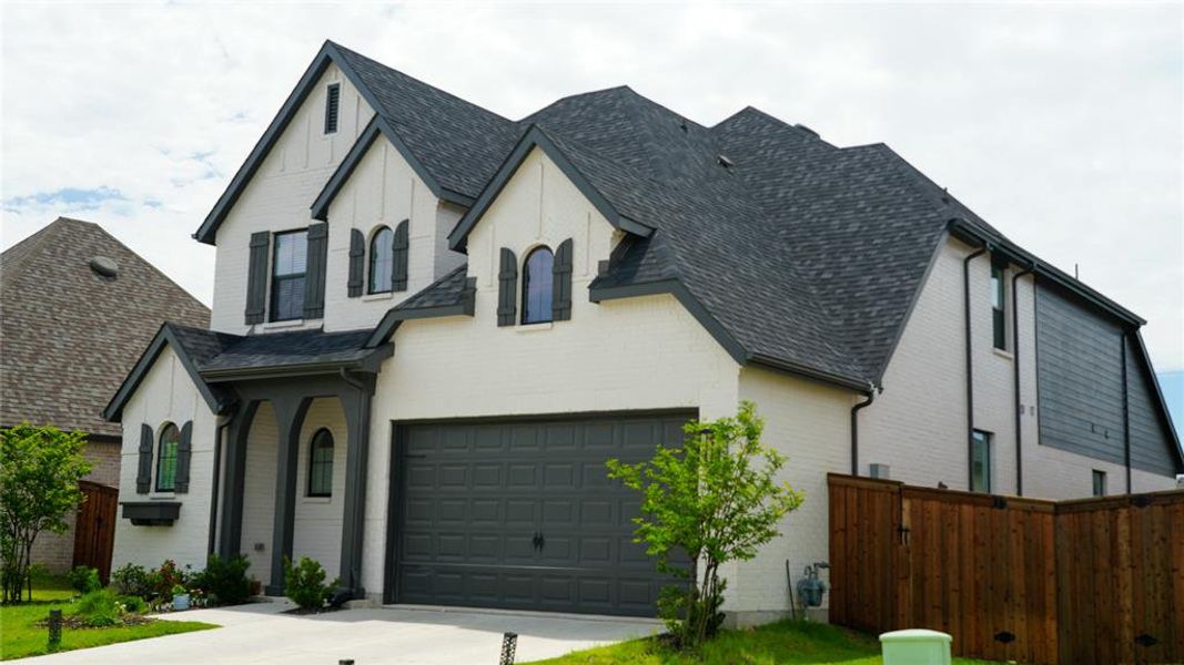 Front exterior of a new home in Sandbrock Ranch, Aubrey, TX, highlighting curb appeal (Image 2). Front exterior of a new home in Sandbrock Ranch, Aubrey, TX, highlighting curb appeal (Image 2).