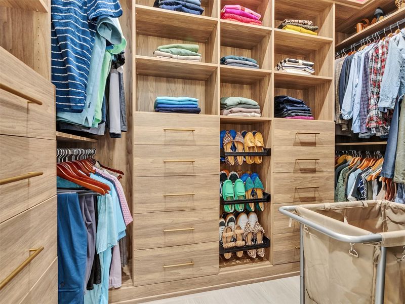 Start your mornings in style in this beautifully organized, spacious walk-in closet — a true extension of the primary suite’s luxury. With built-in drawers, open shelving, and generous hanging space, everything has its place. Picture getting ready for a beachside brunch or an evening out in Galveston, surrounded by calm, coastal-inspired design that makes everyday routines feel effortless and elegant. Start your mornings in style in this beautifully organized, spacious walk-in closet — a true extension of the primary suite’s luxury. With built-in drawers, open shelving, and generous hanging space, everything has its place. Picture getting ready for a beachside brunch or an evening out in Galveston, surrounded by calm, coastal-inspired design that makes everyday routines feel effortless and elegant.