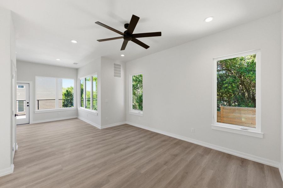 Empty room featuring light wood-style flooring, recessed lighting, and a ceiling fan