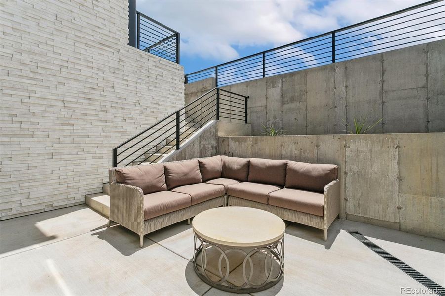 Walk out basement couryard with heat sensors to melt courtyard and stairs up to back patio